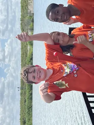 Child Displaying a Fish they Caught